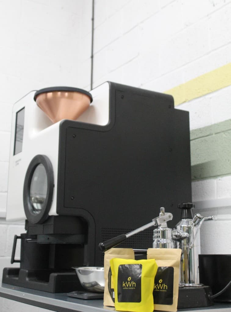 kWh Coffee Bellwether electric roaster with freshly roasted coffee bags