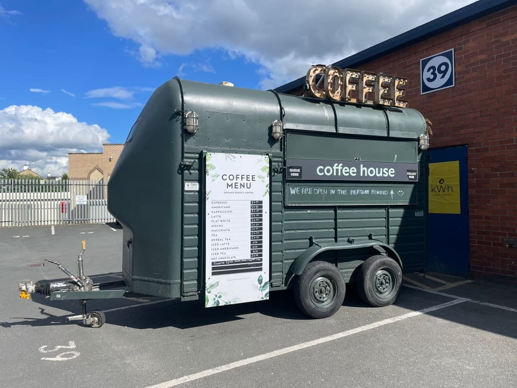 The coffee horsebox as we bought it, branded 'coffee house' with a floral menu board