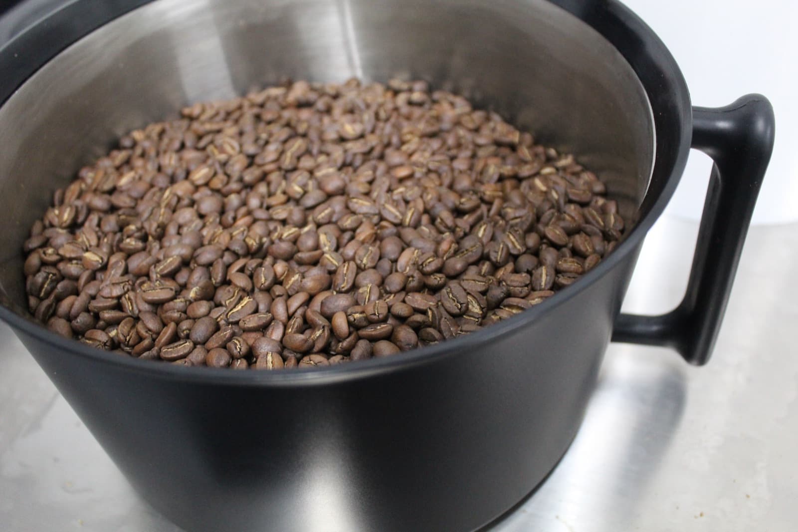 Freshly roasted coffee beans in the cooling bowl of the Bellwether electric roaster